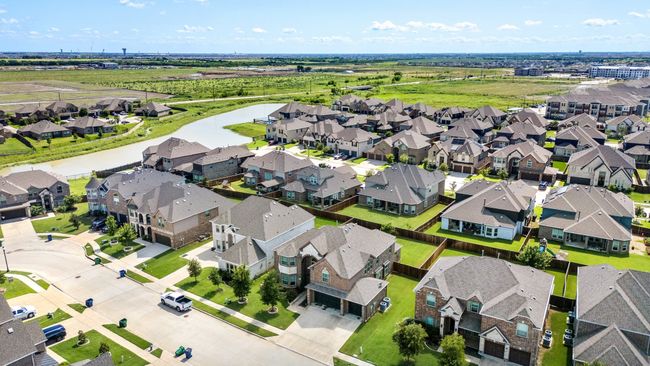 Aerial view of residential area with a nearby body of water | Image 6
