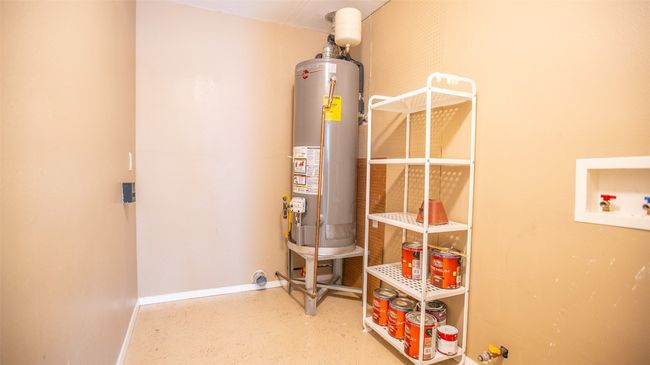 Utility room featuring updated gas water heater | Image 19
