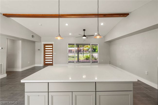 Kitchen with pendant lighting, lofted ceiling with beams, a center island, and ceiling fan | Image 23