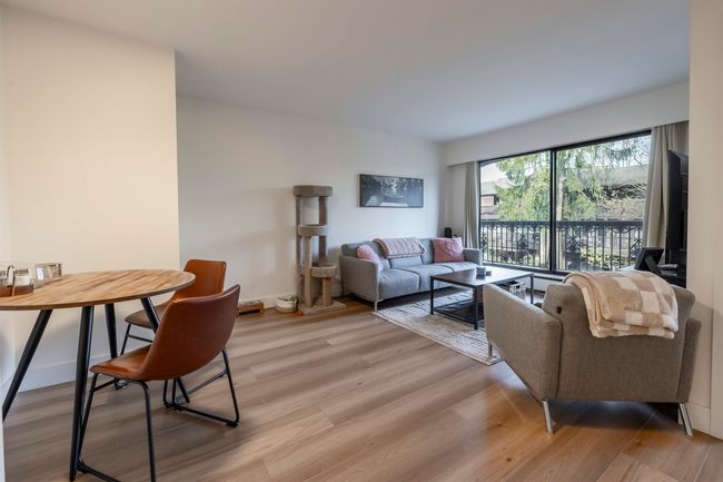 Living area with light wood finished floors and baseboards | Image 7