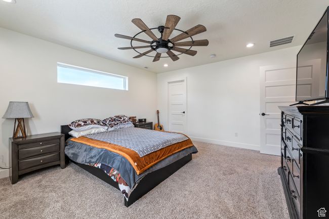 Bedroom featuring recessed lighting, visible vents, a ceiling fan, light carpet, and baseboards | Image 19
