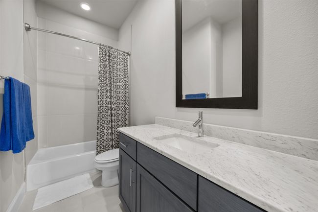 Bathroom featuring vanity, shower / bath combo with shower curtain, recessed lighting, and tile patterned floors | Image 26