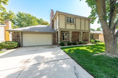 Tudor-style house with a front yard and a garage | Image 2