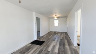 Empty room featuring wood-type flooring and ceiling fan | Image 3