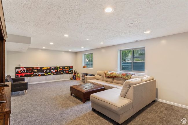 Living room with carpet floors, recessed lighting, baseboards, and a textured ceiling | Image 20