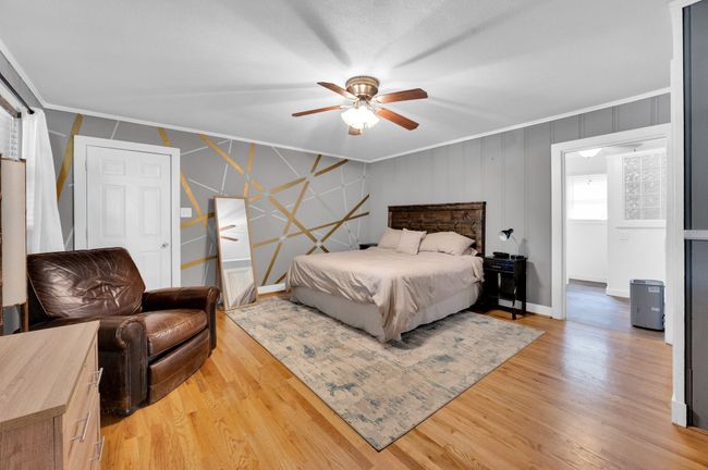 Bedroom featuring ornamental molding, light wood finished floors, baseboards, and a ceiling fan | Image 20