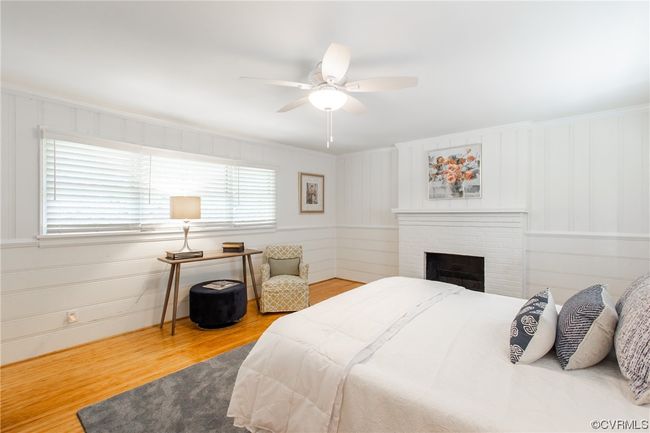 Master bedroom with en-suite bath, fireplace, custom window blinds, ceiling fan, and refinished heart of pine floor | Image 17