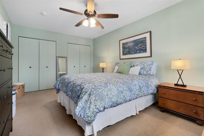 Carpeted bedroom with ceiling fan has two big closets and an en-suite bathroom | Image 12