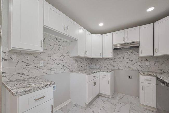 The kitchen offers dedicated spaces for your refrigerator and range, allowing you to personalize with your preferred appliances. | Image 12