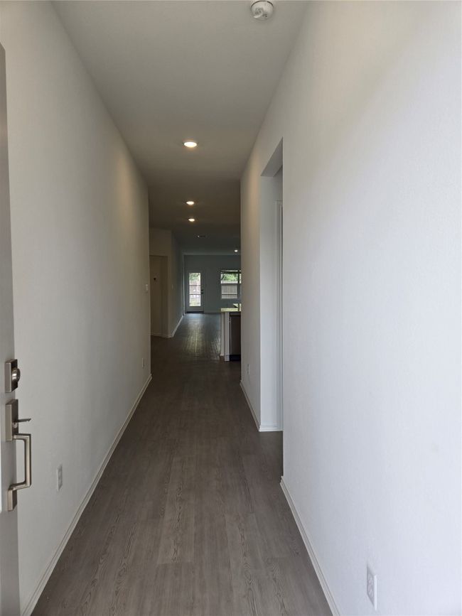 Hallway with dark wood-style flooring and recessed lighting | Image 4