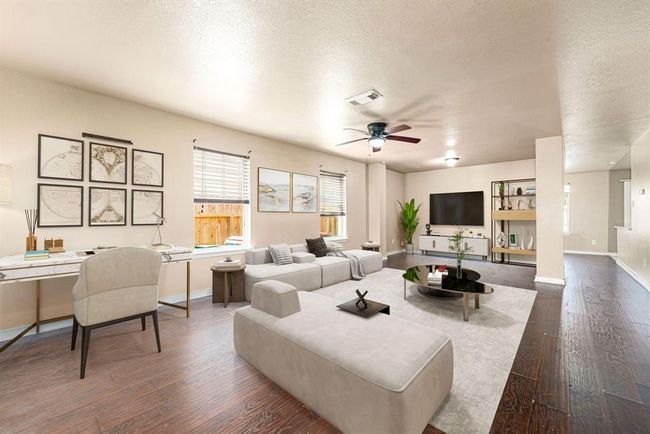 Gather the family and guests together in your lovely living room! Featuring high ceilings, dark stained ceiling fan, custom paint, wood style floors and large windows that provide plenty of natural lighting throughout the day. *Virtually Staged | Image 4