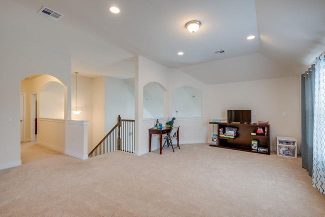 Playroom with visible vents, carpet flooring, and vaulted ceiling | Image 20