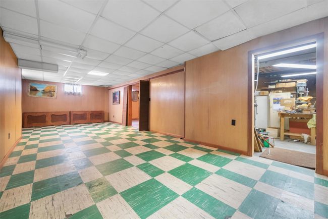 Below grade area with wood walls, a drop ceiling, and tile patterned floors | Image 28