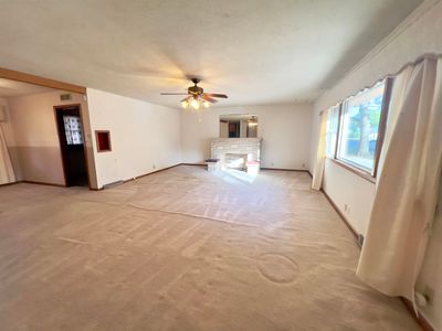 Interior space featuring ceiling fan and light colored carpet | Image 2