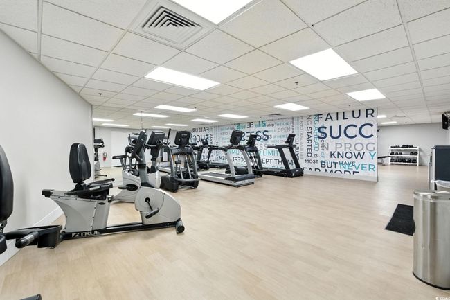 Gym featuring a paneled ceiling and wood finished floors | Image 26