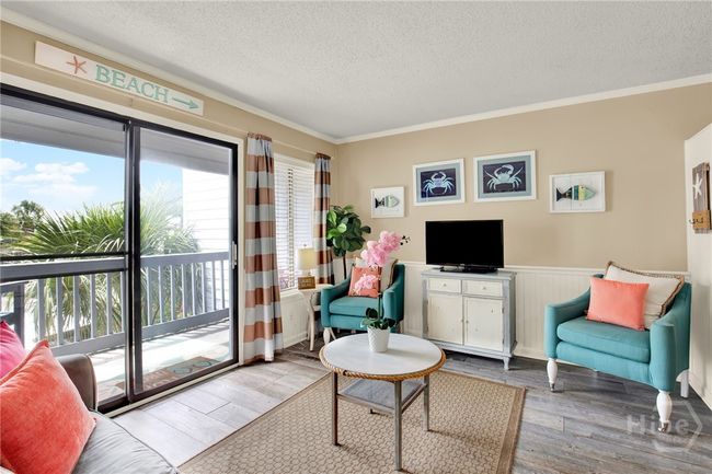 Open Living Area with Sleeper Sofa & Plenty of Natural Light Plus Access to Private Outdoor Balcony with Sunset & Partial Water Views! | Image 5