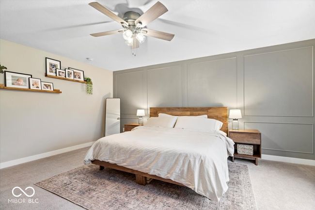 bedroom with a decorative wall, carpet, and ceiling fan | Image 23