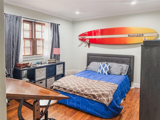 Bedroom featuring baseboards, recessed lighting, wood finished floors, and crown molding | Image 20