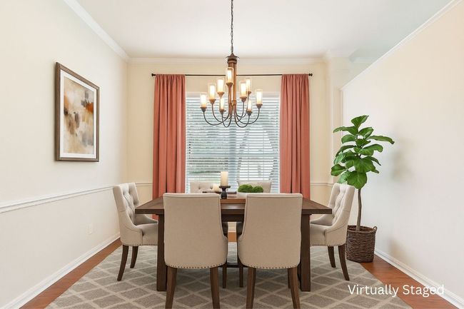 Dining room with a chandelier, wood finished floors, and crown molding | Image 8