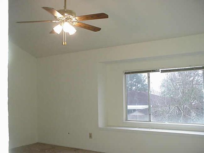 Large living room with hi ceiilings, fan, and a bay window. | Image 8