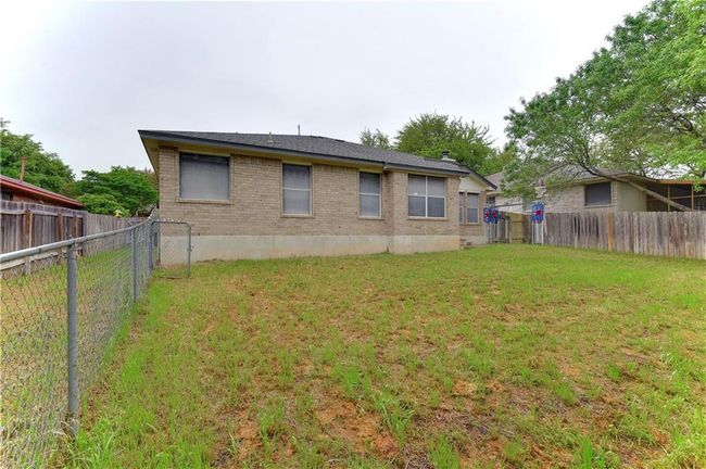Back of house with brick siding and a fenced backyard | Image 17