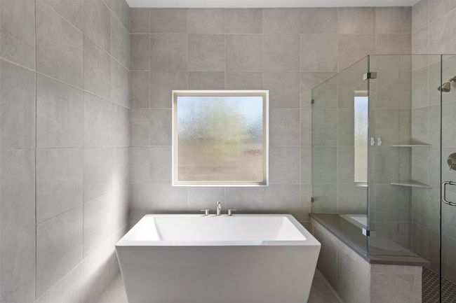 Bathroom with tile walls, a soaking tub, and a shower stall | Image 22