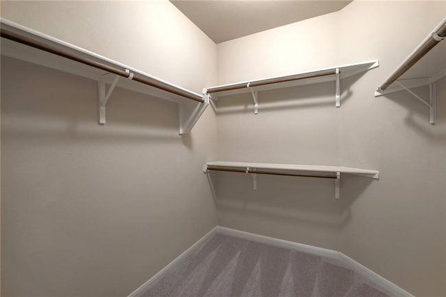 Walk in closet with carpet floors | Image 19
