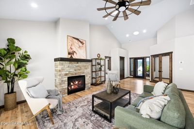 Gorgeous living with gas fireplace, custom wood mantle, and rock surround | Image 2