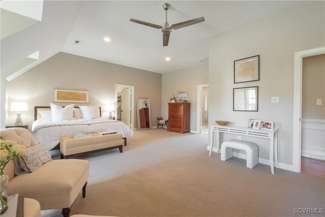 Bedroom featuring ceiling fan, connected bathroom, light colored carpet, visible vents, and recessed lighting | Image 32