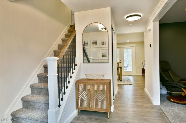 Stairway with baseboards and wood finished floors | Image 8