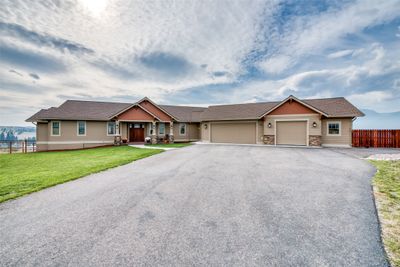 View of front of property featuring a front yard and a garage | Image 1