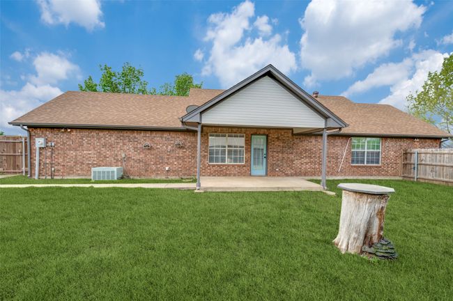 Back of property with a lawn, a patio area, fence, and brick siding | Image 27
