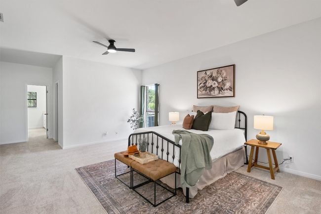 Bedroom featuring ceiling fan, visible vents, baseboards, and light carpet | Image 17