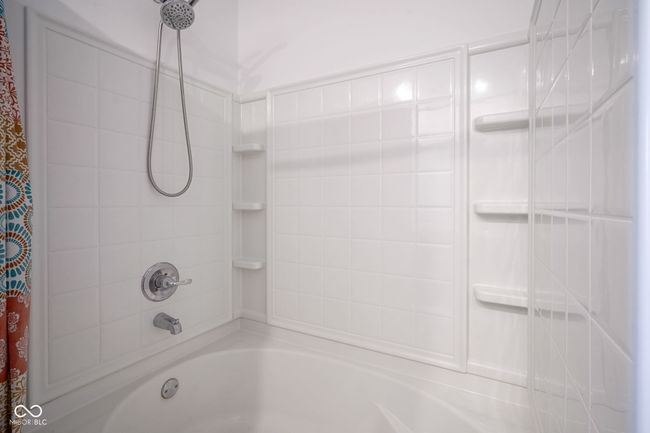 bathroom featuring shower / bathtub combination with curtain | Image 21