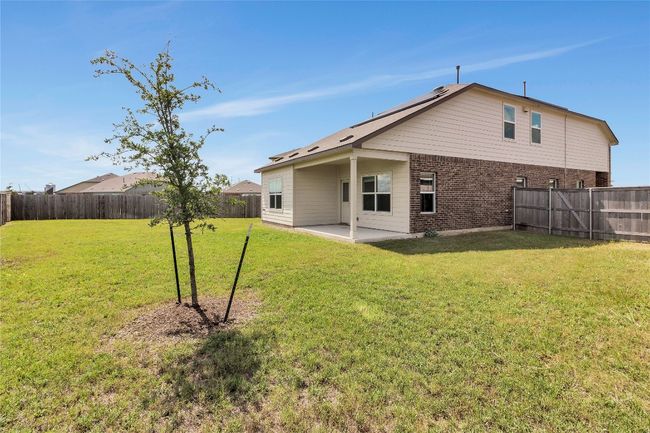 Back of house with brick siding, a fenced backyard, and a patio | Image 33