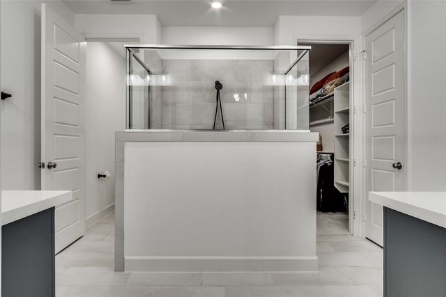 Ensuite Bathroom featuring vanity, a walk in closet, and a tile shower | Image 22