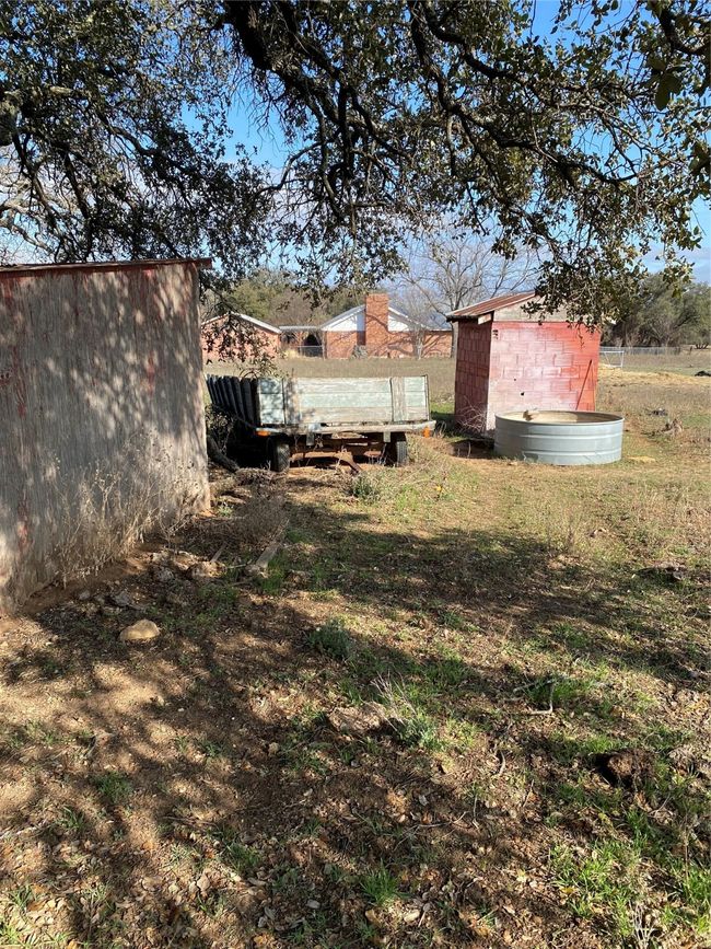 View of yard with a storage shed | Image 26