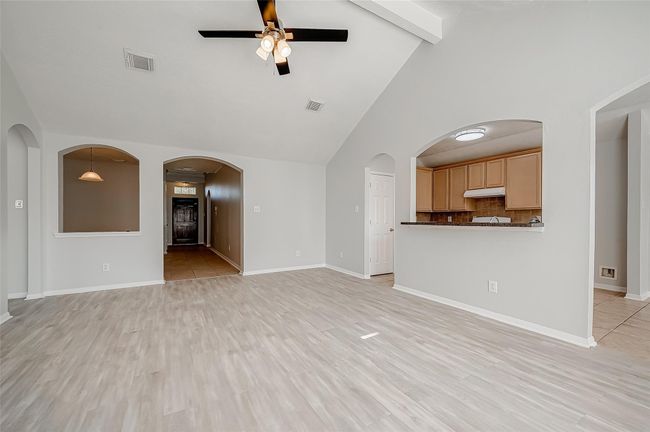 The living room opens to the kitchen and breakfast nook | Image 7