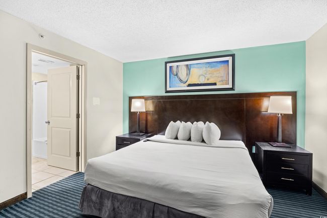 Carpeted bedroom with visible vents and a textured ceiling | Image 11