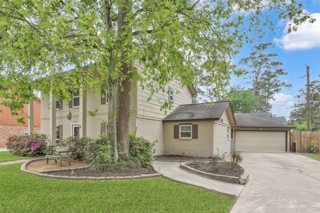 An oversized two-car Garage has an extra storage area and open rafters for additional storage. There is a covered breezeway connecting the Garage to the back door at the Laundry Room. | Image 29