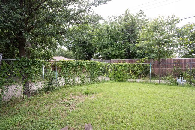 View of fenced backyard | Image 21