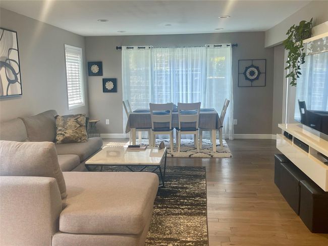 Living area featuring baseboards, wood finished floors, and recessed lighting | Image 6