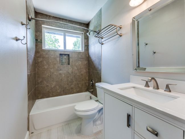 Bathroom featuring vanity, shower / bathtub combination, and toilet | Image 18