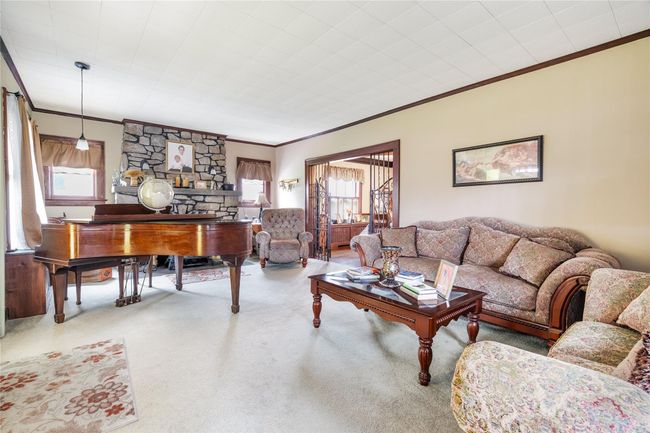 Living room with carpet floors and ornamental molding | Image 4