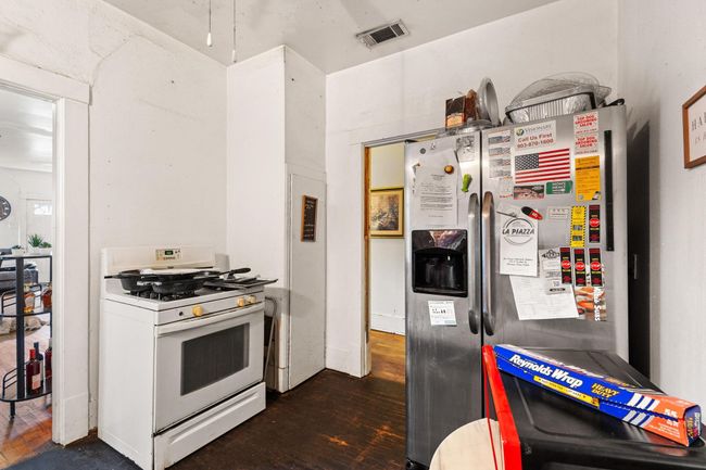 Kitchen featuring white gas range oven and dark wood-style floors | Image 8