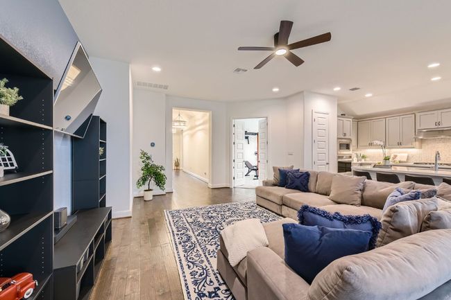 Living area featuring ceiling fan, wood-type flooring, and recessed lighting | Image 9
