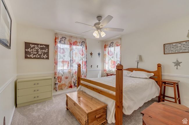 Carpeted bedroom with ceiling fan | Image 32