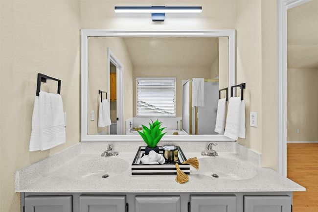 Bathroom with double vanity, wood finished floors, and an enclosed shower | Image 24