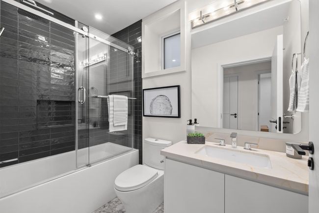 Bathroom featuring toilet, vanity, bath / shower combo with glass door, and recessed lighting | Image 18
