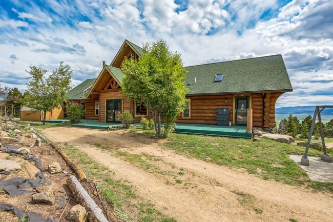Rear view of property featuring log exterior and roof with shingles | Image 6